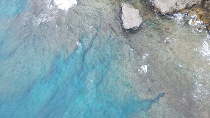 top, rocky shore, coast, aerial view, overhead view, drone, ocean, wave, water's edge, cliff, precipice, rock, nature, environment, swimming, directly above, science, investigation, disaster preventio
