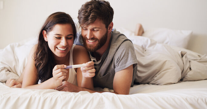 Smile, love and couple with pregnancy test on bed for future, family or baby together in home. Happy, bonding and man with woman for positive pregnant kit with excitement in marriage in bedroom.