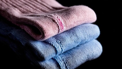 Stack of neatly folded pastel pink and blue socks