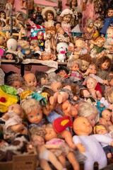A Massive, Cluttered Pile of Vintage Dolls and Toys in a Collectors' Shop.