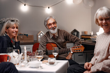 Family members enjoying a warm evening together with food and music played entertainingly.