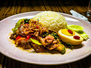 Stir-fried spicy pork leg with Thai herbs, chili, and garlic. Tender pork leg cooked in aromatic Thai spices, served as a flavorful and appetizing dish.