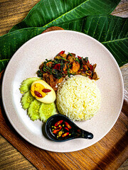 Crispy pork stir-fried with Thai basil, chili, and garlic. Served with savory sauce and fresh herbs, a classic Thai street food dish.