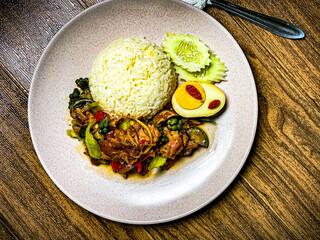 Crispy pork stir-fried with Thai basil, chili, and garlic. Served with savory sauce and fresh herbs, a classic Thai street food dish.