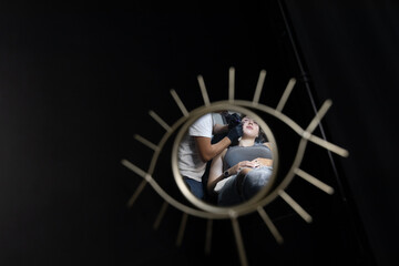 Young woman gets a face tattoo in a professional studio. The session is captured from creative angles, showing the tattooing process and emotions during this bold act of self-expression.