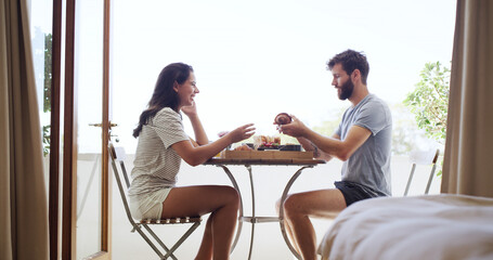 Breakfast, morning and smile with couple on balcony of home together for bonding or hunger. Eating, happy and love with people outdoor at apartment for anniversary, honeymoon or romantic meal