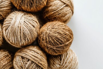 Close-up of natural twine balls arranged artistically on a white background, ideal for crafting projects