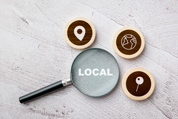 Magnifying glass focusing on the word local with map icons around, concept of local business...