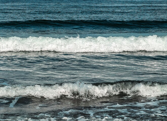 surf waves of clear blue waters of the Arctic Ocean