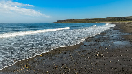 surf waves of clear blue waters of the Arctic Ocean