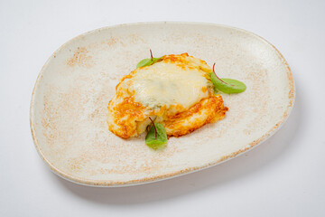 A delicious baked creation featuring golden cheese, complemented by vibrant green herbs
