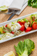 Tasty salad with zucchini, cherry tomatoes, and creamy cheese, beautifully presented
