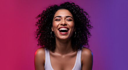 Portrait of a smiling young Asian woman looking directly at the camera with a warm expression, against a dark background