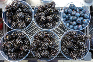 Fresh blackberries and blueberries are on display.