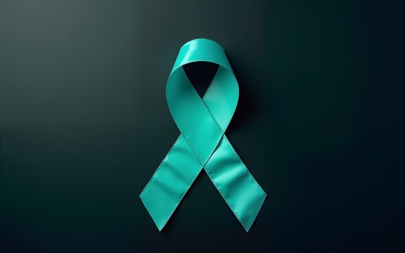 Top view of  teal ribbon on dark background with copy space. Cervical and ovarian cancer, sexual assault, pcos, ptsd, anxiety disorder, agoraphobia and scleroderma awareness concept. High quality