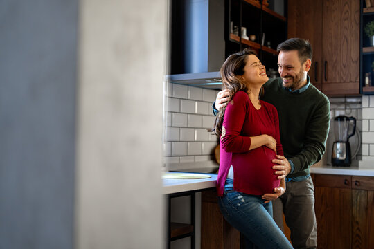 Man in love hugs his pregnant wife, they are waiting together for the baby's arrival. Love, family - Powered by Adobe