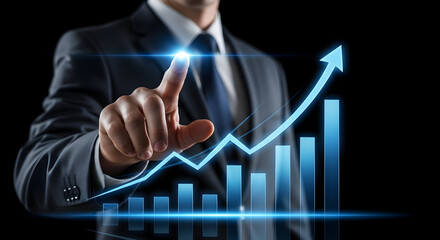 Modern businessman pointing at a digital growth chart, symbolizing business success and innovation.