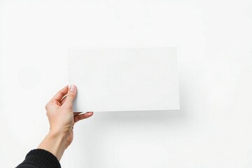 Obraz premium Hand holding a blank white paper or card against a white background