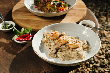 Creamy Scallop Pasta with Mushrooms on Rustic Wooden Table