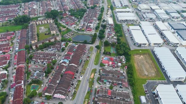 Aerial: Johor Bahru outskirts with traffic and residential area during the day in the state of Johor, Malaysia, reveal drone shot