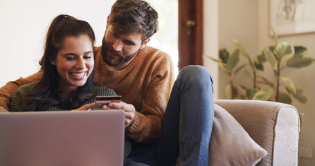 Home, credit card and couple on sofa, laptop and online shopping with banking, purchase and password. Apartment, man and woman on couch, computer and payment with transaction, savings and ecommerce