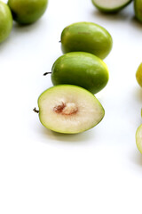 Green jujube fruits on white background.