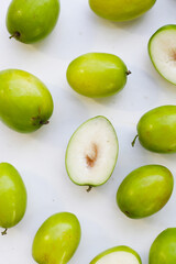 Green jujube fruits on white background.