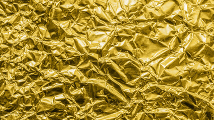 Luxury shiny metallic golden foil crumpled texture background