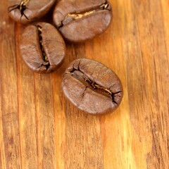 Roasted Coffee Beans on Rustic Wooden Surface