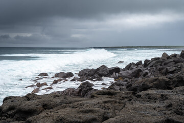 Calm seascape with rocks at Playa Loberia, San Cristobal