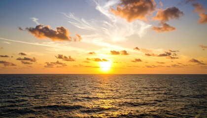 Obraz premium A breathtaking sunset over the ocean, with golden light reflecting on the water.