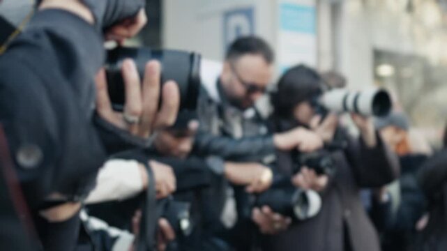 Paparazzi taking photos of a celebrity