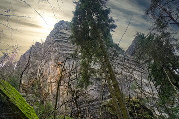 Mighty rock formation in a forest under a dramatic sky, natural monumental.