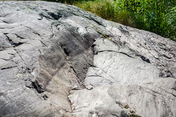 Close-up of a weathered, textured rock surface with natural striations
