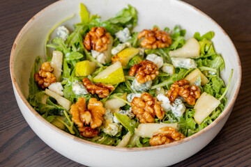 healthy fall salad with arugula pear cheese and candied walnuts