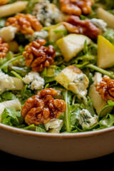 healthy fall salad with arugula pear cheese and candied walnuts