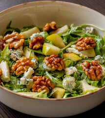healthy fall salad with arugula pear cheese and candied walnuts