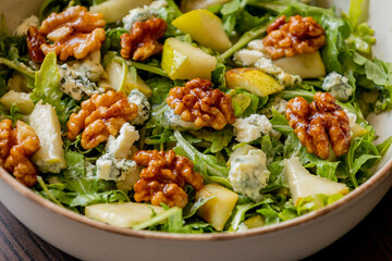 healthy fall salad with arugula pear cheese and candied walnuts