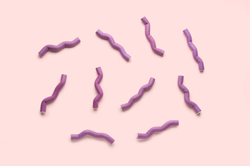 Hair curlers on pink background