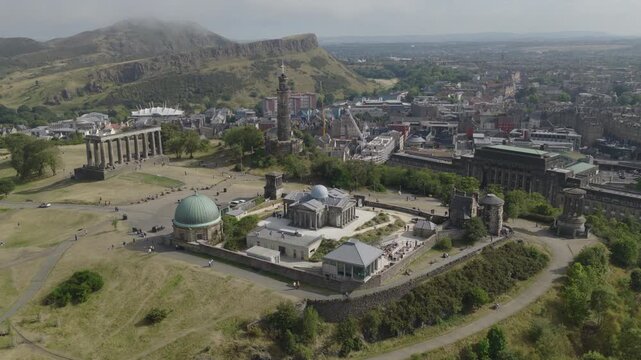 Establishing aerial view of Edinburgh showing Calton Hill with the National Monument of Scotland, Nelson Monument and Dugald Stewart Monument. Capital of Scotland, United Kingdom