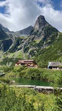Scenic view of mountain lake and hut (Chata pri zelenom plese) in High Tatras, Slovakia.  Zelene Pleso (Green lake) mountain lake in High Tatras, Slovakia