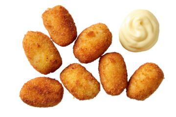 Crispy, golden-brown, bite-sized snacks arranged atop a dark background, with a dollop of creamy sauce