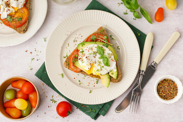 Plates of tasty sandwiches with egg on light background