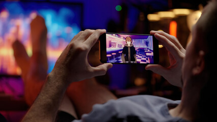 Watching Japanese anime show on smartphone chilling behind the computer