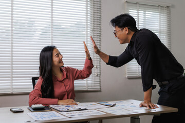 Business people giving high five after successful corporate meeting