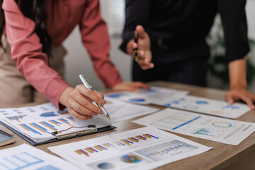 Business colleagues analyzing financial charts and graphs for strategic decision making