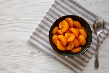 Organic Canned Mandarin Oranges in a Bowl, top view. Copy space.