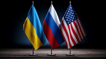 Three flags displayed on stands: Ukraine, Russia, and the USA. The scene symbolizes international negotiations and peace efforts amid conflict.