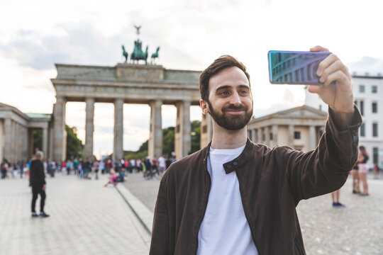 Man taking smartphone selfies, Berlin, Germany