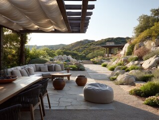 Fototapeta premium A patio with a table and chairs, a couch, and a large umbrella. The table is covered with a tablecloth
